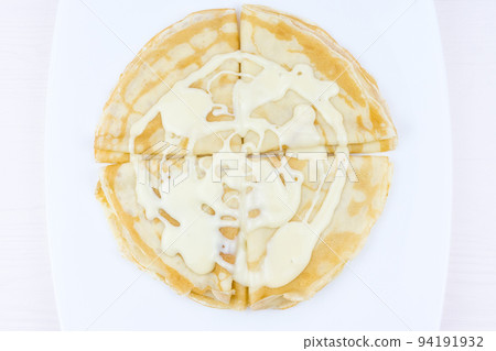 Pancakes drenched with condensed milk 94191932