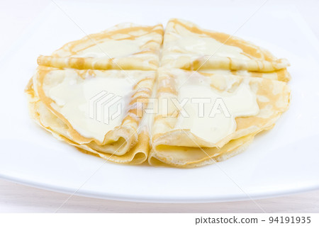 Pancakes drenched with condensed milk Pancakes drenched with condensed milk 94191935