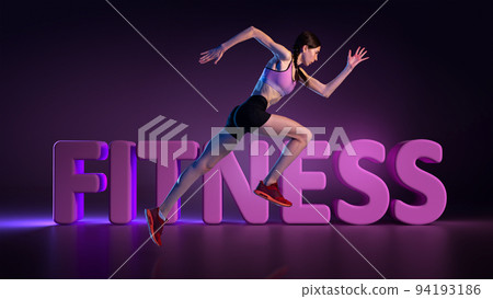 Athletic young woman in sports uniform running along 3d lettering over dark background in neon light. Sport, action, fitness, youth concept. Athletic young woman in sports uniform running along 3d lettering over dark background in neon light. Sport, action, fitness, youth concept. 94193186