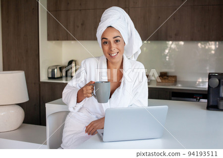 Content woman drinking coffee at home Content woman drinking coffee at home 94193511
