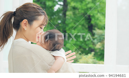 A woman holding a baby A woman holding a baby 94194681