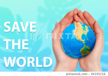 The Earth Day. Female hands holds a little ball of planet on a turquoise background with a silhouette of monstera leaves. Concept of Save the world and environment 94195216