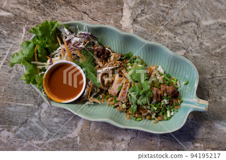 Squid stuffed with Pork mince and Garlic sprinkle with dill, corianders and spring onion served with chili sauce. Squid stuffed with Pork mince and Garlic sprinkle with dill, corianders and spring onion served with chili sauce. 94195217