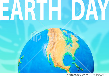 The Earth Day. Planet on a turquoise background with a silhouette of monstera leaves. Concept of Save the planet and environment 94195218