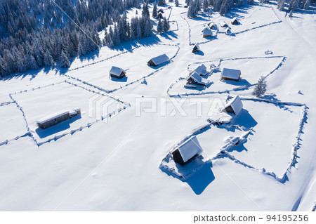 Snow covered remote village. Aerial view Snow covered remote village. Aerial view 94195256