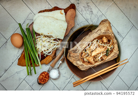 Stir fried soft turnip cake or Fried radish cake (chai tow kway) with bean sprout and chives in ceramic plate. Stir fried soft turnip cake or Fried radish cake (chai tow kway) with bean sprout and chives in ceramic plate. 94195572