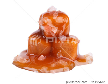 Sweet caramel candies and sauce, isolated on white background. Delicious salty caramel. Sweet caramel candies and sauce, isolated on white background. Delicious salty caramel. 94195684