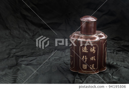 One antique chinese tea leaf iron storage jar. Translation meaning chinese characther is the name of the tea, Traditional chinaese metal canister. One antique chinese tea leaf iron storage jar. Translation meaning chinese characther is the name of the tea, Traditional chinaese metal canister. 94195806
