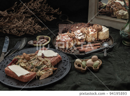 Sausage spaghetti with Cheese on bread served with Cinnamon Rolls, Dark chocolate bars, cookies and pieces. Sausage spaghetti with Cheese on bread served with Cinnamon Rolls, Dark chocolate bars, cookies and pieces. 94195893