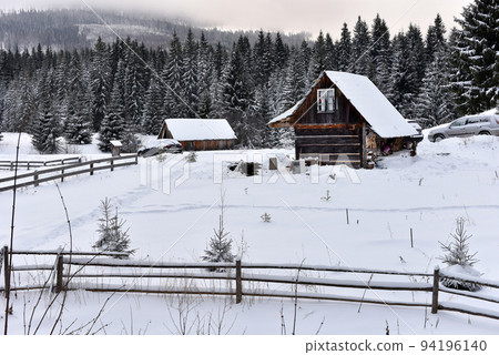 Alpine house covered with snow in the mountains Alpine house covered with snow in the mountains 94196140