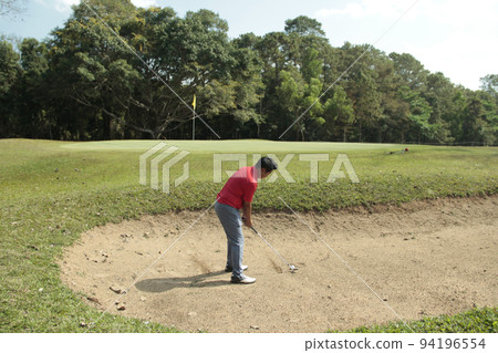 Golfer are playing game golf and hitting go on green grass mountain background. Asia male player game shot in summer. Golfer are playing game golf and hitting go on green grass mountain background. Asia male player game shot in summer. 94196554