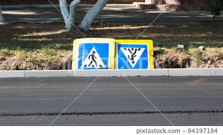 Road signs Pedestrian crossing lie on the ground for the duration of the repair 94197184