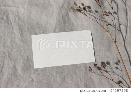 Blank textured business card mockup with dry grass, plant in sunlight. Beige linen background, sunlight, shadow overlay. Modern template for branding identity. Autumn, winter design. Flat lay, top 94197298