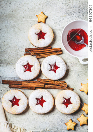 Christmas tree from strawberry linzer cookies on gray background. Festive dessert, winter treat. 94197505