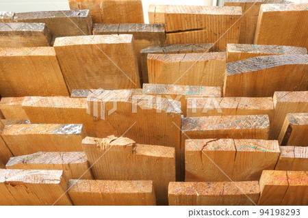 Wooden boards are stacked in a sawmill or carpentry shop. Sawing drying and marketing of wood 94198293