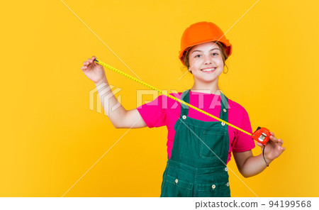 Tools to improve yourself. future engineer. happy kid use tape measure repairing tool. building construction site. child architect worker. labor day. childhood development. teenager girl assistant Tools to improve yourself. future engineer. happy kid use tape measure repairing tool. building construction site. child architect worker. labor day. childhood development. teenager girl assistant 94199568