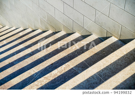 Staircase in the city, black and white pattern on the stairs on a sunny day. Staircase in the city, black and white pattern on the stairs on a sunny day. 94199832
