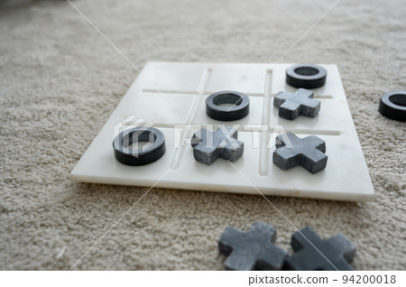 Marble Tic Tac Toe or OX board game on soft carpet with copy space. concept of strategy, risk, competition in business. Marble Tic Tac Toe or OX board game on soft carpet with copy space. concept of strategy, risk, competition in business. 94200018