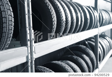 Tires on rack in car service workshop Tires on rack in car service workshop 94200529
