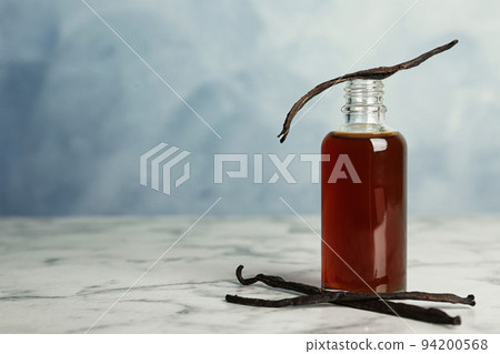 Aromatic homemade vanilla extract on marble table 94200568