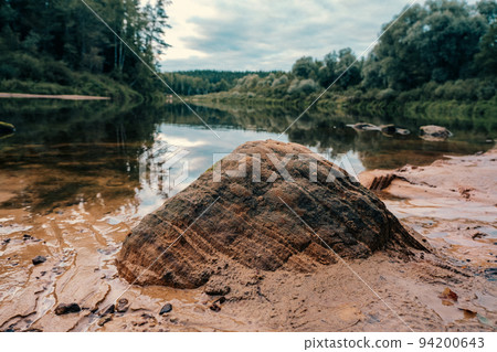 Scenic landscape of the Gauja river. Sandy stones on the shore. Summer nature in Latvia. Gaujas national park. Scenic landscape of the Gauja river. Sandy stones on the shore. Summer nature in Latvia. Gaujas national park. 94200643