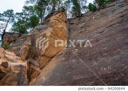 Scenic landscape of the Gauja river. Sandy stones on the shore. Summer nature in Latvia. Gaujas national park. Scenic landscape of the Gauja river. Sandy stones on the shore. Summer nature in Latvia. Gaujas national park. 94200644