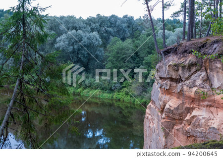 Scenic landscape of the Gauja river. Sandy stones on the shore. Summer nature in Latvia. Gaujas national park. Scenic landscape of the Gauja river. Sandy stones on the shore. Summer nature in Latvia. Gaujas national park. 94200645