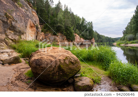 Scenic landscape of the Gauja river. Sandy stones on the shore. Summer nature in Latvia. Gaujas national park. 94200646