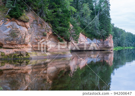 Scenic landscape of the Gauja river. Sandy stones on the shore. Summer nature in Latvia. Gaujas national park Scenic landscape of the Gauja river. Sandy stones on the shore. Summer nature in Latvia. Gaujas national park 94200647