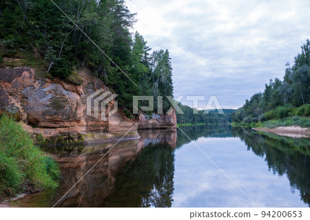 Scenic landscape of the Gauja river. Sandy stones on the shore. Summer nature in Latvia. Gaujas national park. Scenic landscape of the Gauja river. Sandy stones on the shore. Summer nature in Latvia. Gaujas national park. 94200653