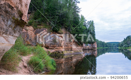 Scenic landscape of the Gauja river. Sandy stones on the shore. Summer nature in Latvia. Gaujas national park. 94200655