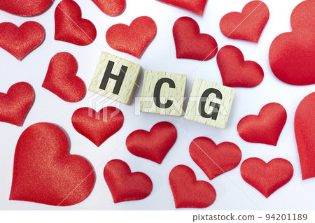 WHO -Human Chorionic Gonadotropin on wooden cubes with red heart shape. 94201189