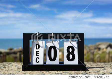 Dec 08 calendar date text on wooden frame with blurred background of ocean. Dec 08 calendar date text on wooden frame with blurred background of ocean. 94201246