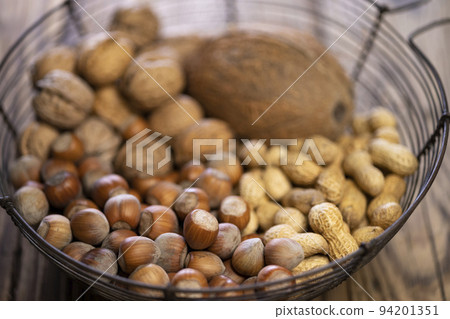 different kinds of nuts on a wooden background different kinds of nuts on a wooden background 94201351