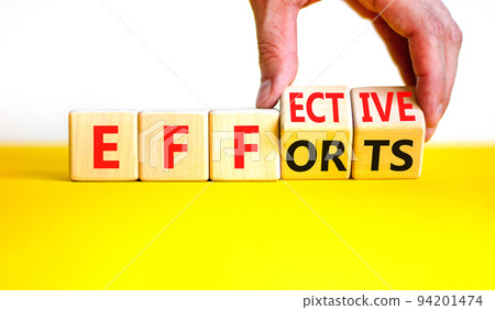 Effective efforts symbol. Concept words Effective efforts on wooden cubes. Businessman hand. Beautiful yellow table white background. Business effective efforts concept. Copy space. 94201474