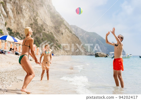 Happy family on the beach in Corfu, Greece 94202417