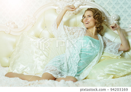 Young beautiful woman waking up on bed 94203169