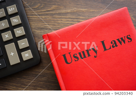 Usury laws book near a dark calculator. Usury laws book near a dark calculator. 94203340