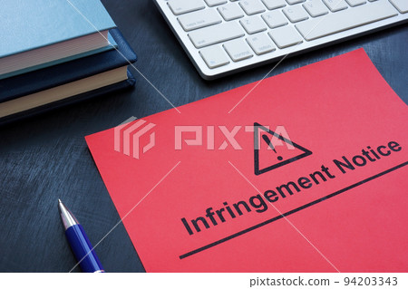 Infringement notice near a keyboard and notepads. Infringement notice near a keyboard and notepads. 94203343