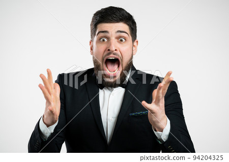 Man in tuxedo depicts amazement, showing WOW delight face effect. Surprised excited happy guy in Man in tuxedo depicts amazement, showing WOW delight face effect. Surprised excited happy guy in 94204325