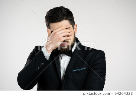 Portrait of man doing facepalm gesture, like no, I forgot. Unhappy guy in tuxedo feeling sorrow Portrait of man doing facepalm gesture, like no, I forgot. Unhappy guy in tuxedo feeling sorrow 94204328