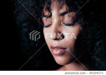 Portrait of afro girl. Tempting woman with perfect makeup and curly hairstyle smiling. Glamour Portrait of afro girl. Tempting woman with perfect makeup and curly hairstyle smiling. Glamour 94204571