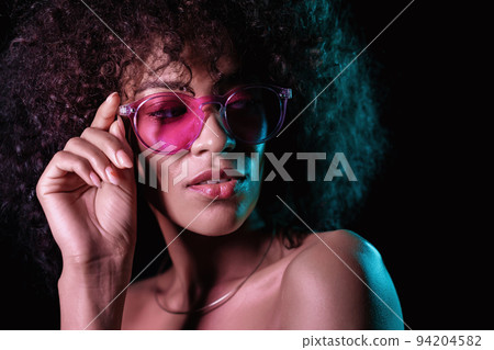 Alluring unusual girl with curly afro hair corrects her glasses. Sexy woman with perfect makeup Alluring unusual girl with curly afro hair corrects her glasses. Sexy woman with perfect makeup 94204582