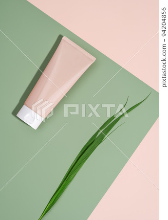 Cosmetic skin care product body lotion, shampoo, face cream or mask with grass on pastel beige and green background in flat lay style. Natural beauty and organic cosmetics concept with copy space for Cosmetic skin care product body lotion, shampoo, face cream or mask with grass on pastel beige and green background in flat lay style. Natural beauty and organic cosmetics concept with copy space for 94204856