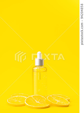 Vitamin C formula ampoule. Serum in transparent bottle with lemon on bright yellow background. Beauty and health concept. Mockup for your design with copy space. Vitamin C formula ampoule. Serum in transparent bottle with lemon on bright yellow background. Beauty and health concept. Mockup for your design with copy space. 94204858