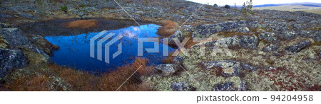 Eye of the North. Blue small lake among mountain tundra. 94204958
