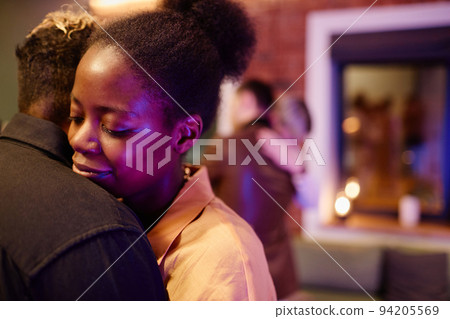 Happy young woman embracing her girlfriend during romantic slow dance Happy young woman embracing her girlfriend during romantic slow dance 94205569