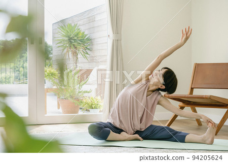 Middle-aged woman doing yoga at home 94205624