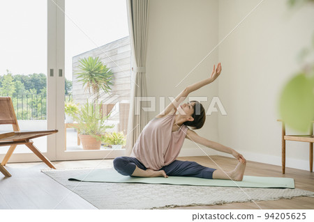 Middle-aged woman doing yoga at home 94205625
