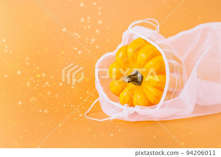 Different varieties of Pumpkins in mesh bag of fabric on orange background.Autumn concept.Copy space.Composition of pumpkins.Happy Thanksgiving.Vegetable fall food concept.Autumn Halloween Pumpkins. Different varieties of Pumpkins in mesh bag of fabric on orange background.Autumn concept.Copy space.Composition of pumpkins.Happy Thanksgiving.Vegetable fall food concept.Autumn Halloween Pumpkins. 94206011